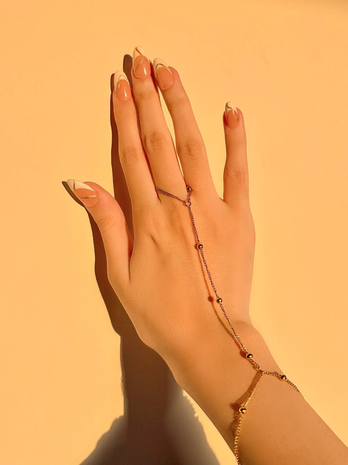 Golden beaded hand chain bracelet